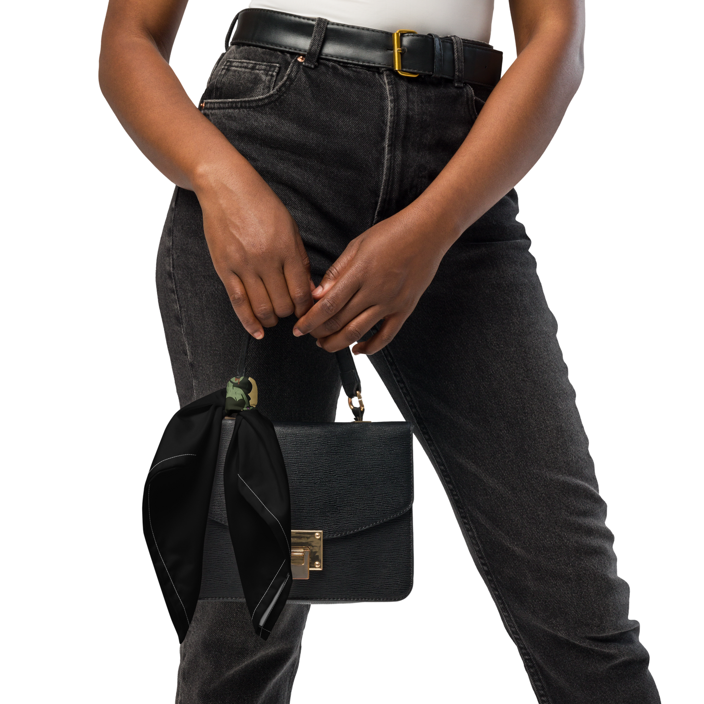 Person holding a black handbag with a balck scarf on it. The design features a green pinup-style zombie girl holding flowers, with a banner underneath that reads “CREEPY ALL YEAR.”