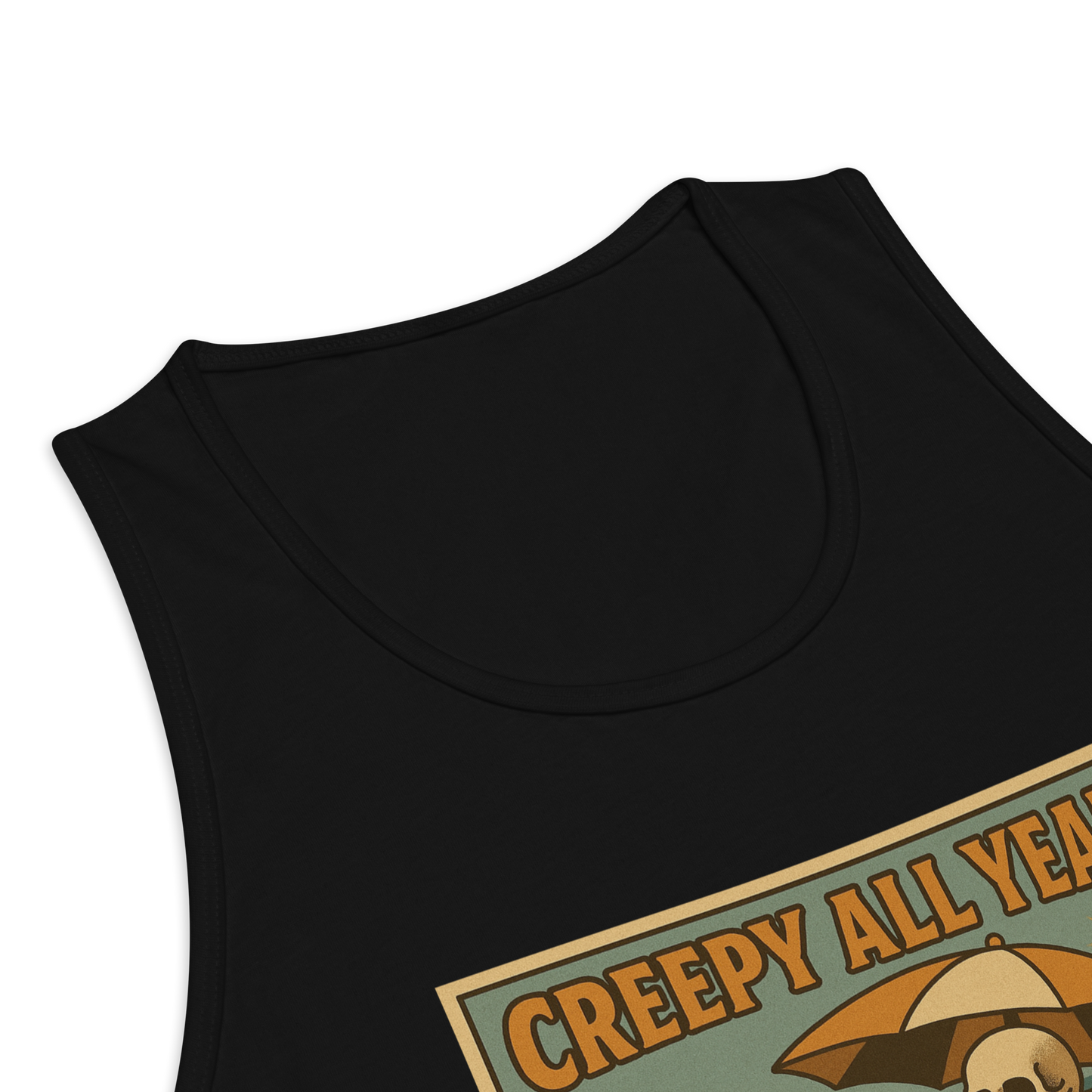 This is a zoom in of a black tank top with a retro-style illustration of a grinning skeleton lounging on a beach chair under an orange umbrella. The skeleton is holding a pumpkin-shaped drink cup with a straw and relaxing by the ocean, with a bright sun in the sky and a life preserver in the sand. The words “Creepy All Year” appear boldly at the top