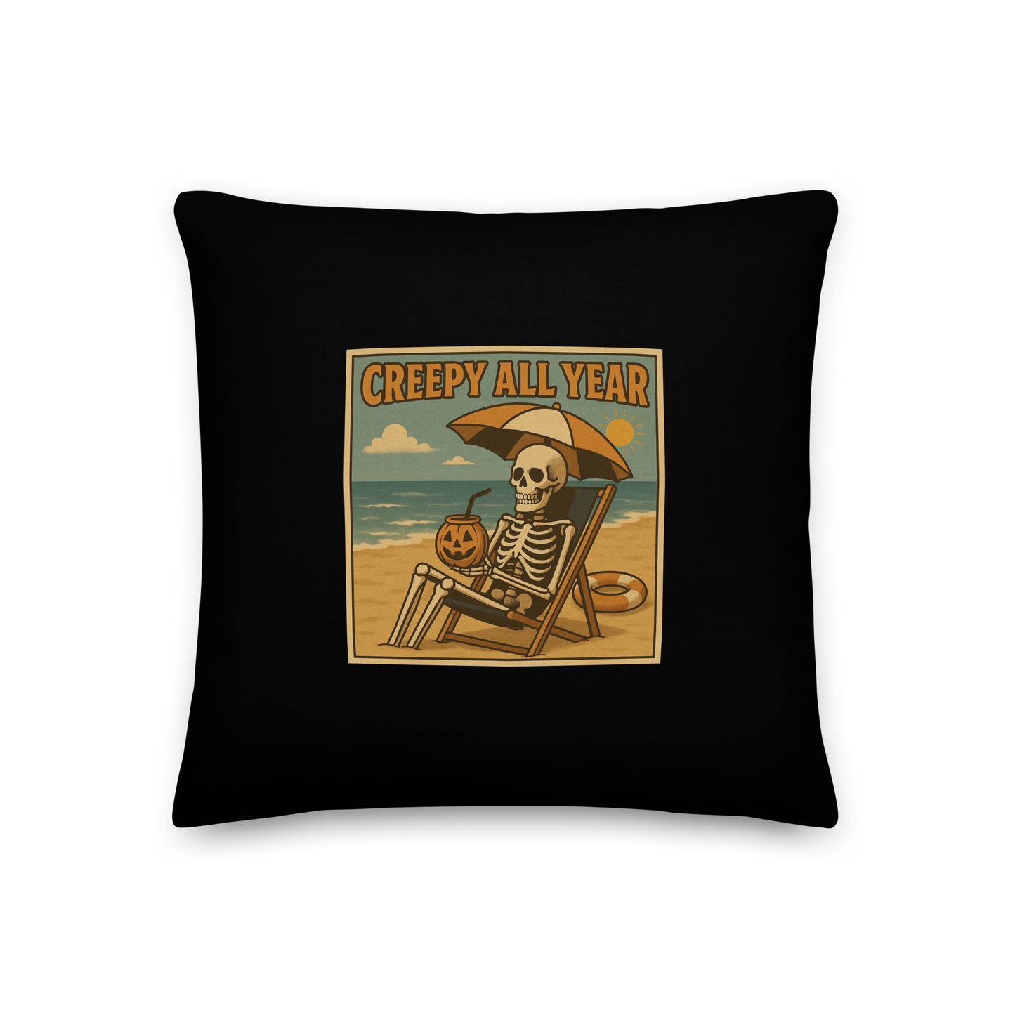 This is a black throw pillow with a retro-style illustration of a grinning skeleton lounging on a beach chair under an orange umbrella. The skeleton is holding a pumpkin-shaped drink cup with a straw and relaxing by the ocean, with a bright sun in the sky and a life preserver in the sand. The words “Creepy All Year” appear boldly at the top