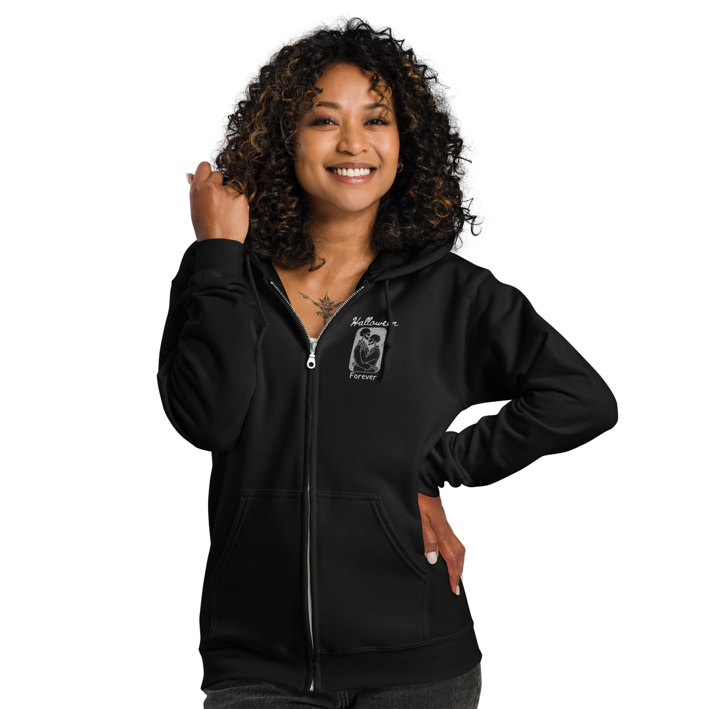 This is a woman with black hair wearing a black zip-up hoodie that has a hugging skeleton couple that is grey and says Halloween Forever