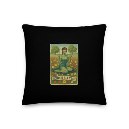 This is a black throw pillow with a design illustration of a sassy zombie pinup girl standing in a floral field, wearing tattered lingerie and flipping off the viewer with both hands. She has green skin, vintage curls, and a bold attitude. The design blends horror and humor, with a pastel color palette and creepy cute vibes 