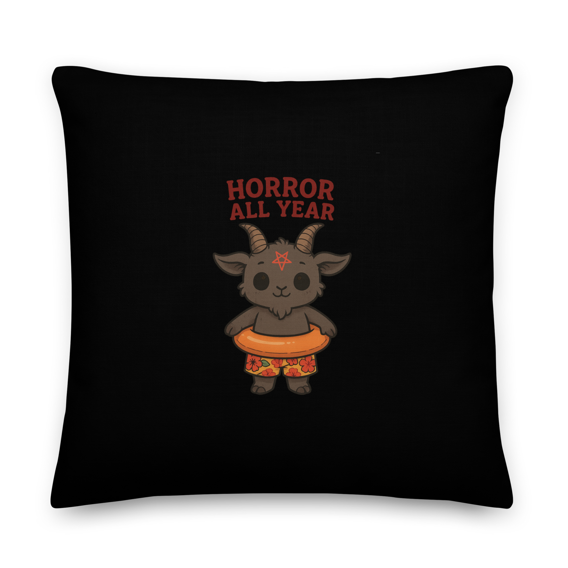 This is a black throw pillow and on the front has a cartoon illustration of a baby Baphomet goat with curved horns and a playful grin, wearing bright floral swim trunks while floating in a colorful inner tube. The character is set against a light background with the bold text “Horror All Year” above in red letters