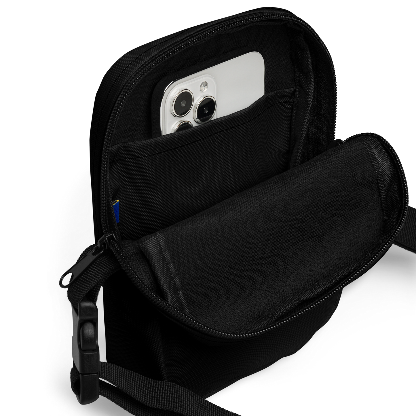 This is the inside of a black crossbody bag with a Día de los Muertos–style illustration of a male and female skeleton holding hands, surrounded by marigolds, vines, and folk art patterns. The skeletons wear traditional black clothing, the man in a suit and hat, the woman with a floral crown with a red heart and leaves at the bottom and the text Creepy All Year. Rendered in warm tones of orange, green, and cream, symbolizing eternal love and remembrance on the outside