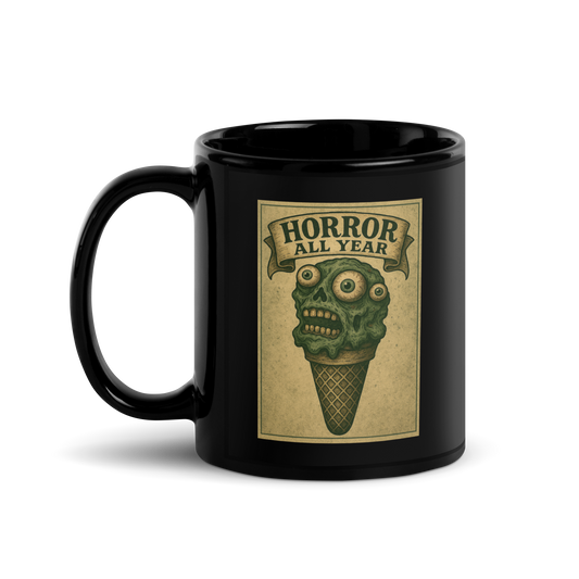 This is a black mug with a vintage-style illustration of a zombie-themed ice cream cone with a green, melting undead face and bulging eyeballs. Above the cone, a horror banner reads "Horror All Year" on a distressed parchment background