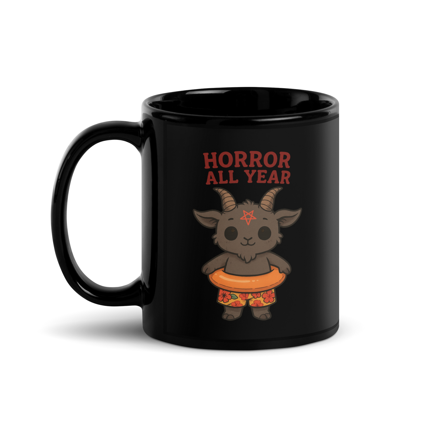 This is a black glossy mug with a cartoon illustration of a baby Baphomet goat with curved horns and a playful grin, wearing bright floral swim trunks while floating in a colorful inner tube. The character is set against a light background with the bold text “Horror All Year” above in red letters 