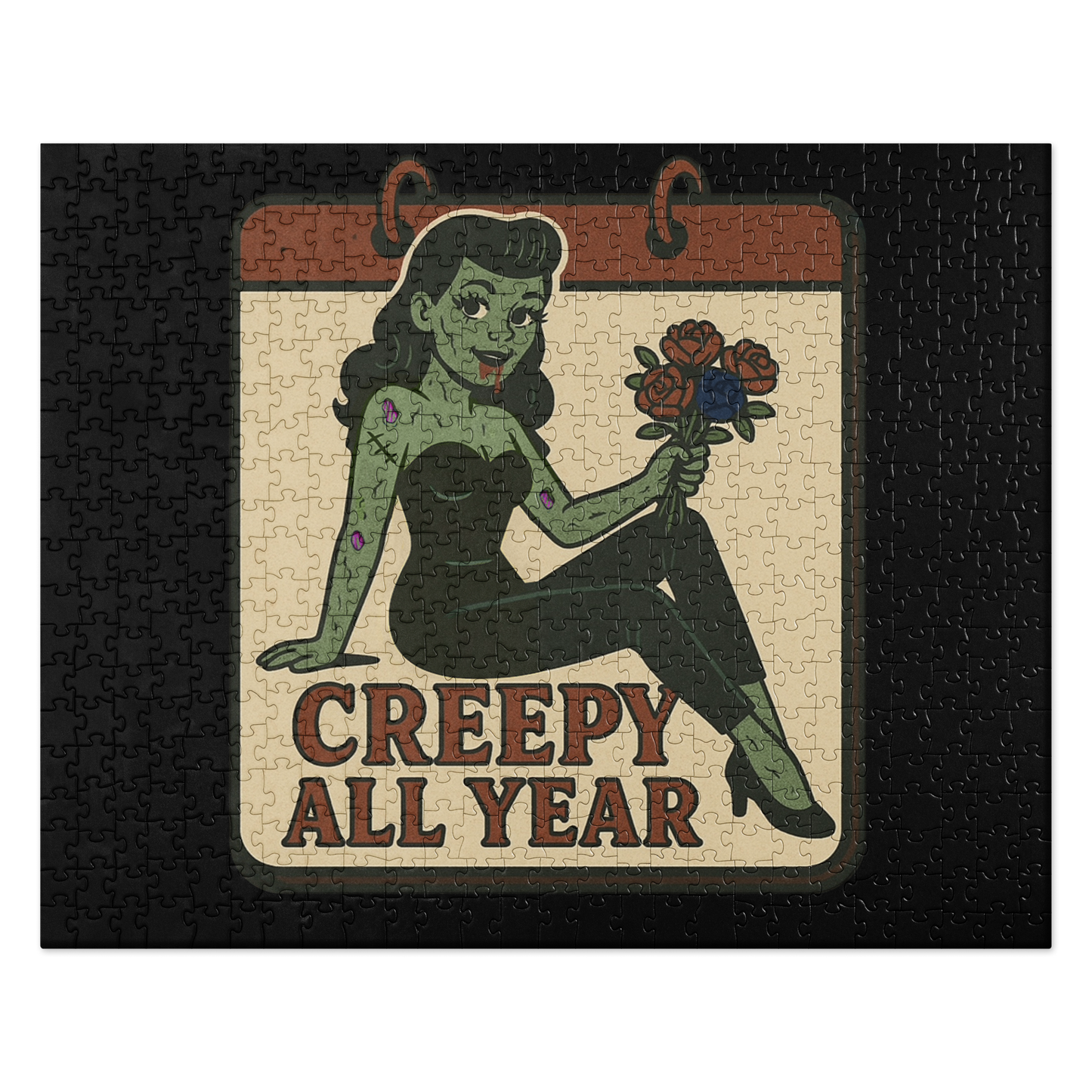Black puzzle with a graphic design. The design features a green pinup-style zombie girl holding flowers, with a banner underneath that reads “CREEPY ALL YEAR.”