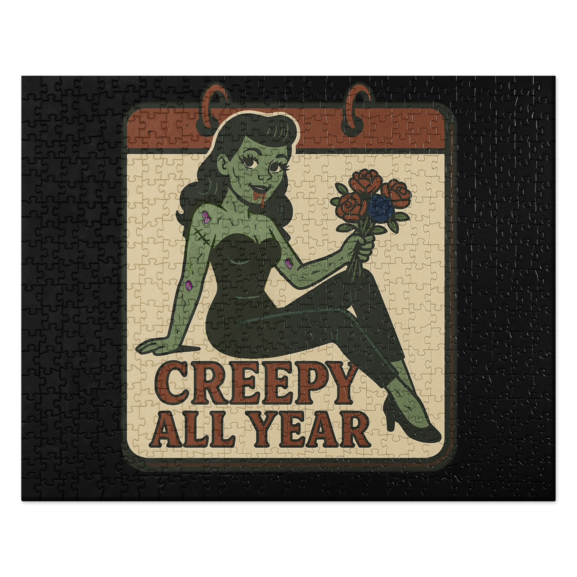 Black puzzle with a graphic design. The design features a green pinup-style zombie girl holding flowers, with a banner underneath that reads “CREEPY ALL YEAR.”