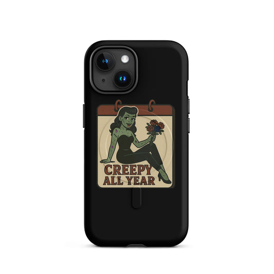 Magsafe iphone case with a graphic design. The design features a green pinup-style zombie girl holding flowers, with a banner underneath that reads “CREEPY ALL YEAR.”