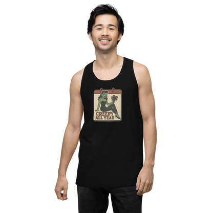 A black tank top on a man with dark hair with a vintage-style design on the front. The design features a green pinup-style zombie girl holding flowers, with a banner underneath that reads “CREEPY ALL YEAR.”