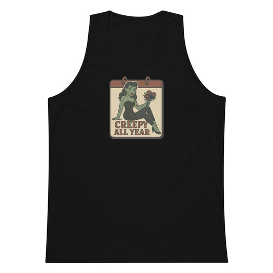 A black tank top with a vintage-style design on the front. The design features a green pinup-style zombie girl holding flowers, with a banner underneath that reads “CREEPY ALL YEAR.”