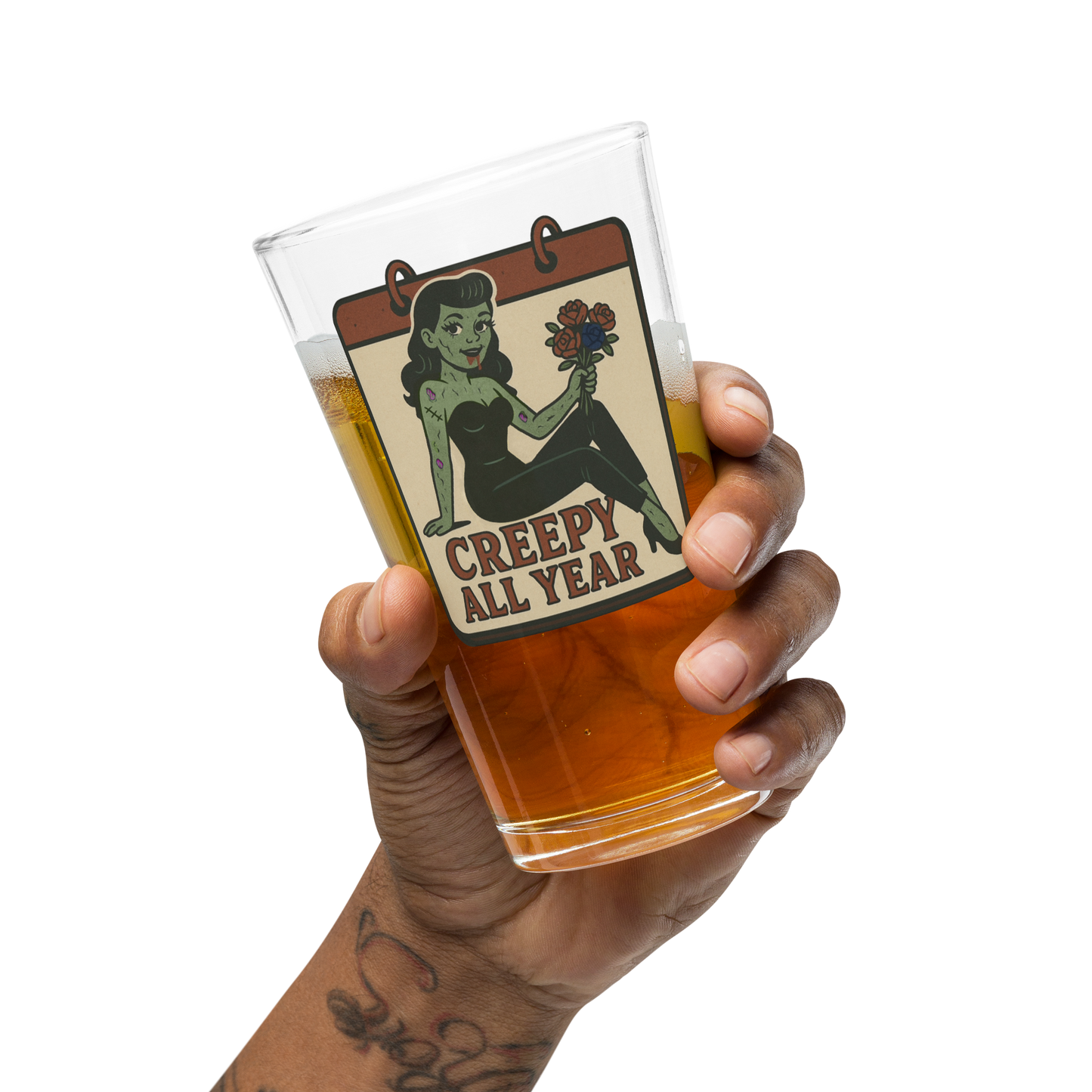 Hand holding a glass of beer with a 'Creepy All Year' label featuring a vintage-style illustration.