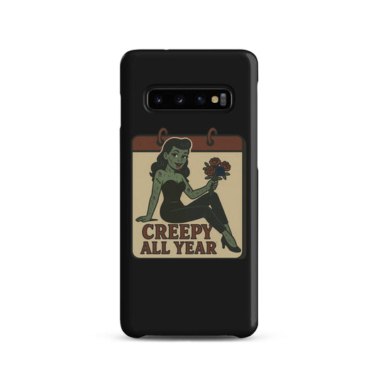 Snap case for Samsung with a graphic design. The design features a green pinup-style zombie girl holding flowers, with a banner underneath that reads “CREEPY ALL YEAR.”