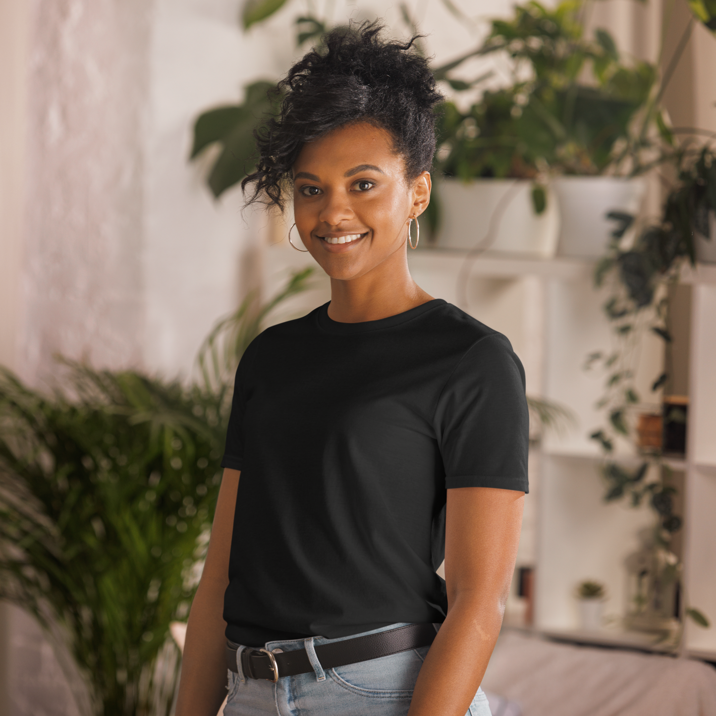 A black t-shirt with a vintage-style design being worn by a girl with black hair. The design features a green pinup-style zombie girl holding flowers, with a banner underneath that reads “CREEPY ALL YEAR.”