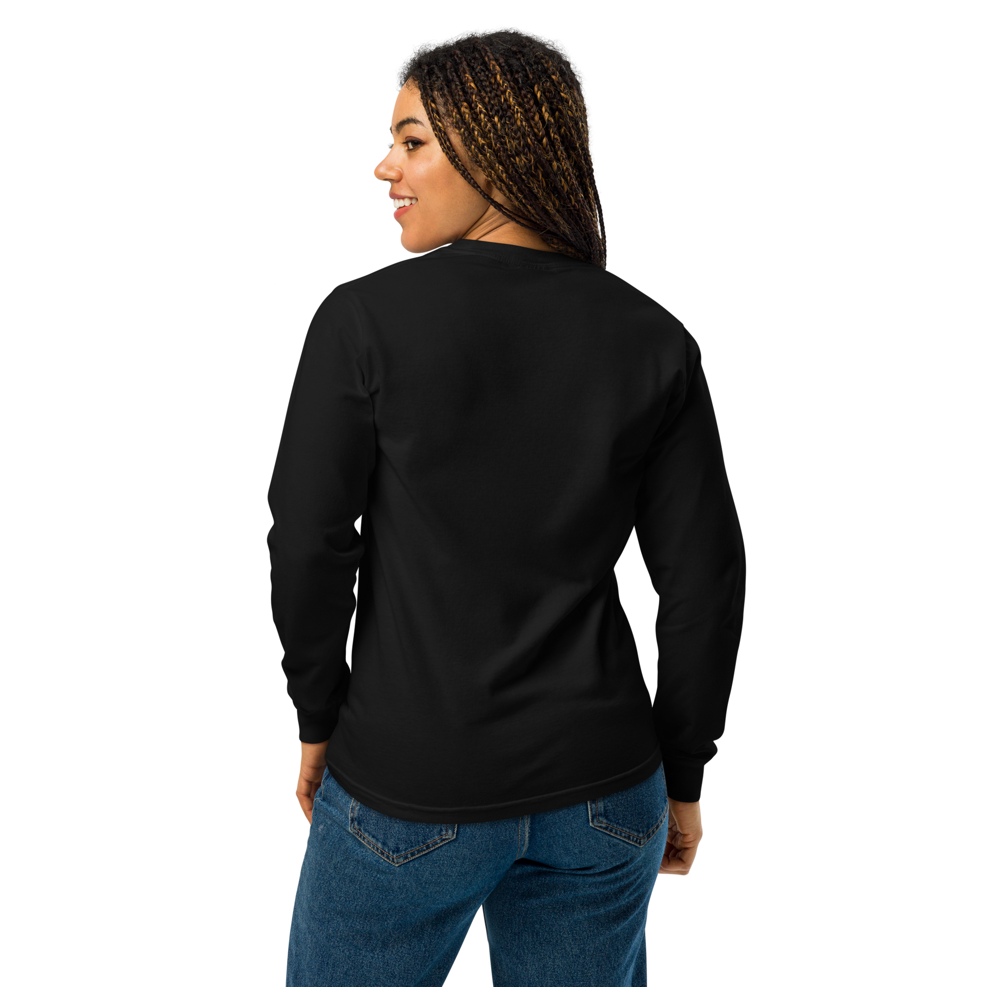 A girl with braids wearing jeans and showing the back of a black long sleeve t-shirt. The design on the front features a green pinup-style zombie girl holding flowers, with a banner underneath that reads “CREEPY ALL YEAR.”