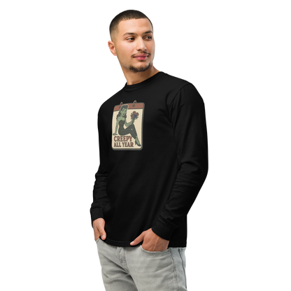 A man with dark hair wearing jeans and a black long sleeve t-shirt. The design features a green pinup-style zombie girl holding flowers, with a banner underneath that reads “CREEPY ALL YEAR.”