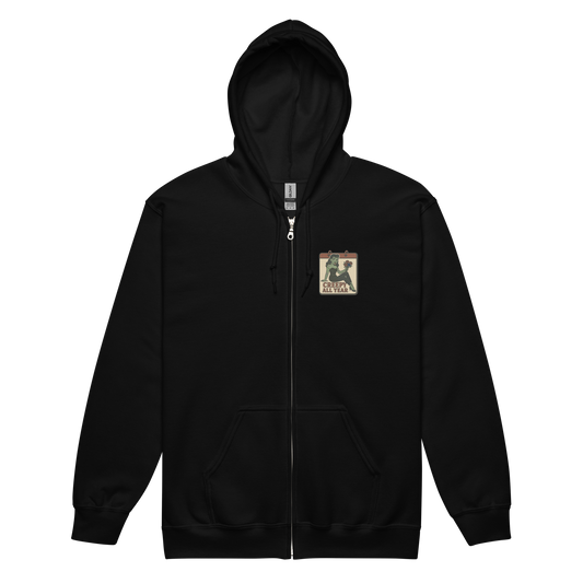 Black zip-up hoodie with a small vintage-style patch on the left chest area. The patch features a green pinup-style zombie girl holding flowers, with a banner underneath that reads “CREEPY ALL YEAR.”