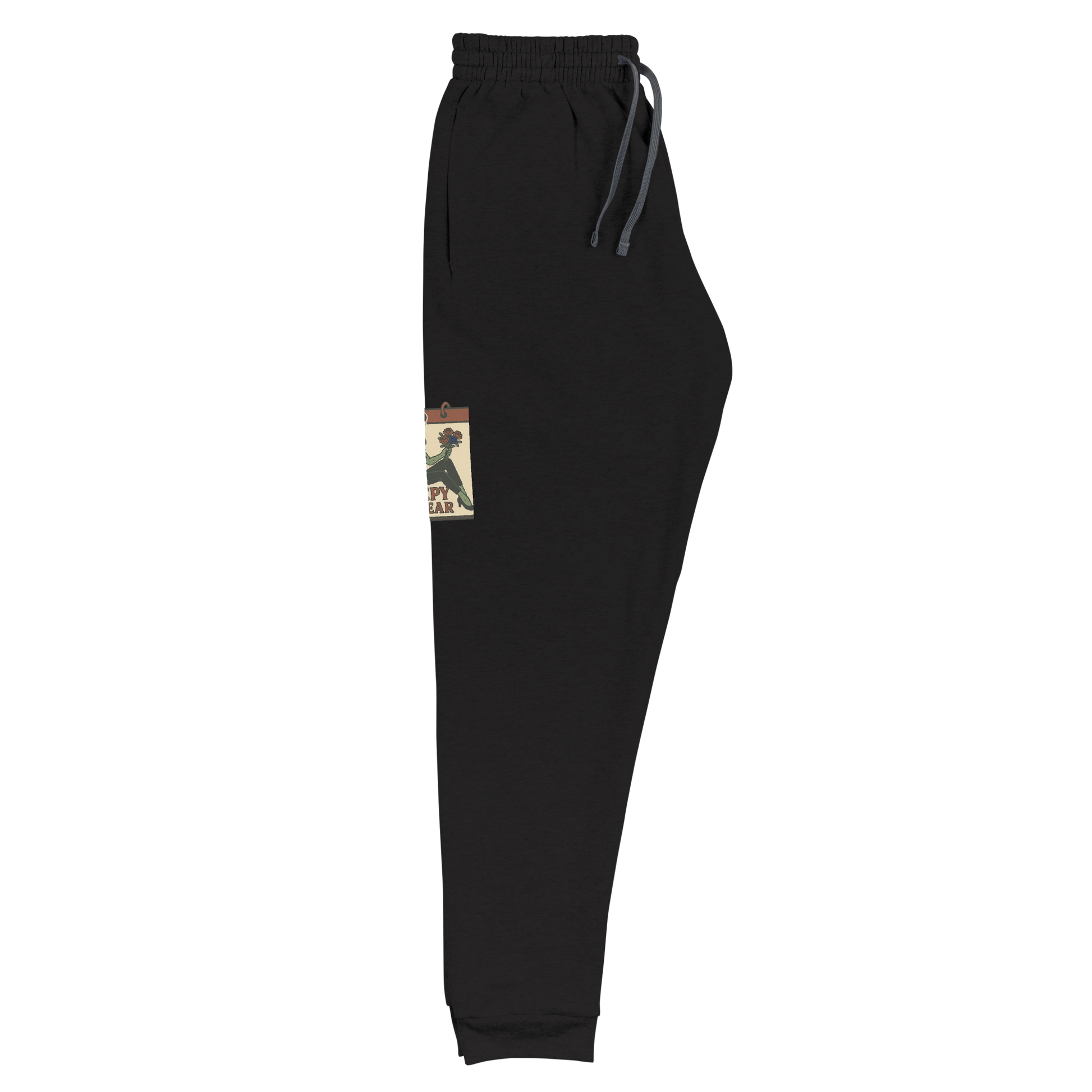 Black joggers that are folded, with a vintage-style design on the front. The design features a green pinup-style zombie girl holding flowers, with a banner underneath that reads “CREEPY ALL YEAR.”