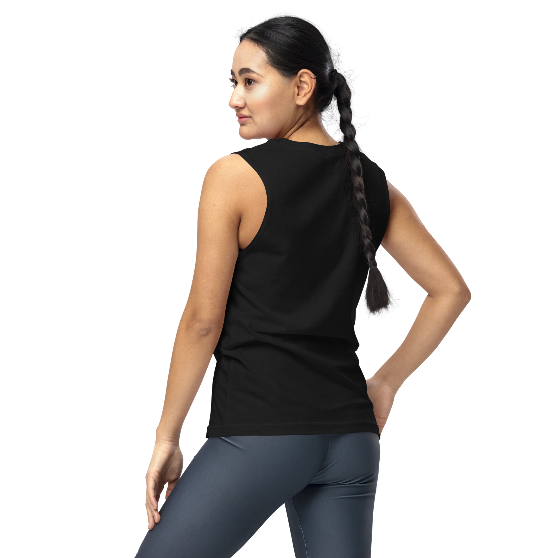 A girl with dark hair braided wearing leggings and muscle shirt showing the back. The design on the front features a green pinup-style zombie girl holding flowers, with a banner underneath that reads “CREEPY ALL YEAR.”