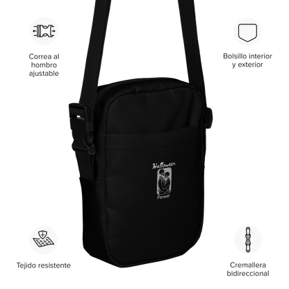 This is a side view of a black crossbody bag that has a hugging skeleton couple that is grey and says Halloween Forever 