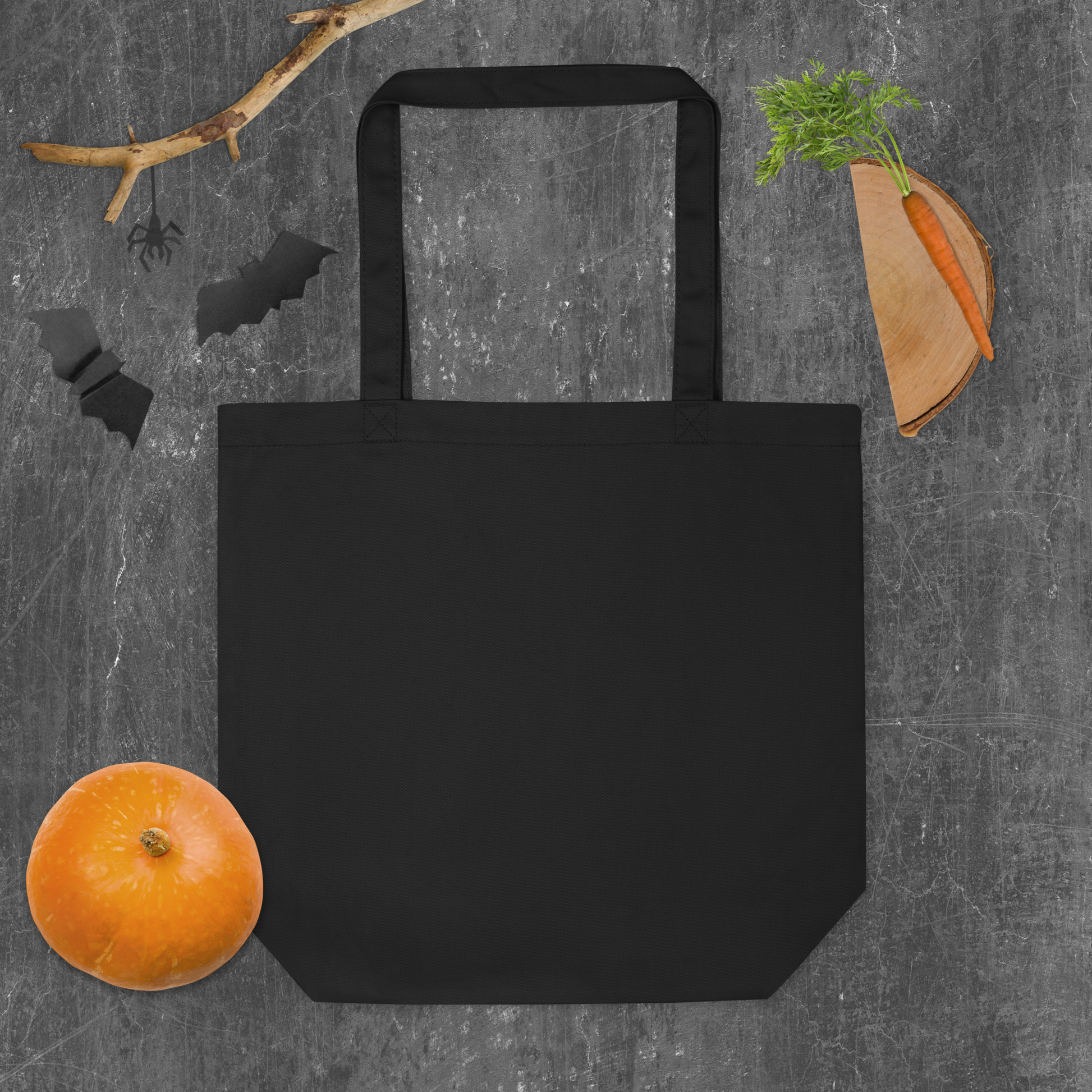 This is a grey Halloween background with  the back of a black tote bag that has a hugging skeleton couple that is grey and says Halloween Forever on the front