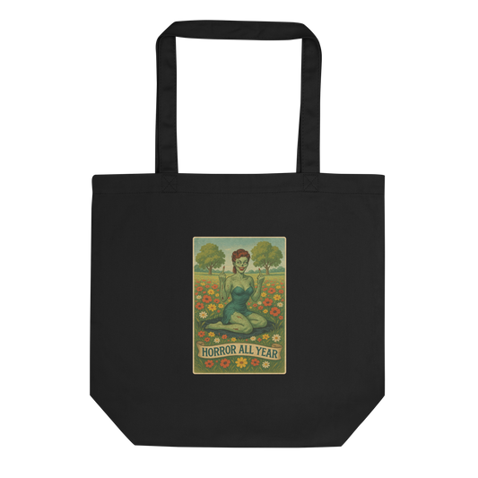 This is a black eco tote bag with a design illustration of a sassy zombie pinup girl standing in a floral field, wearing tattered lingerie and flipping off the viewer with both hands. She has green skin, vintage curls, and a bold attitude. The design blends horror and humor, with a pastel color palette and creepy cute vibes