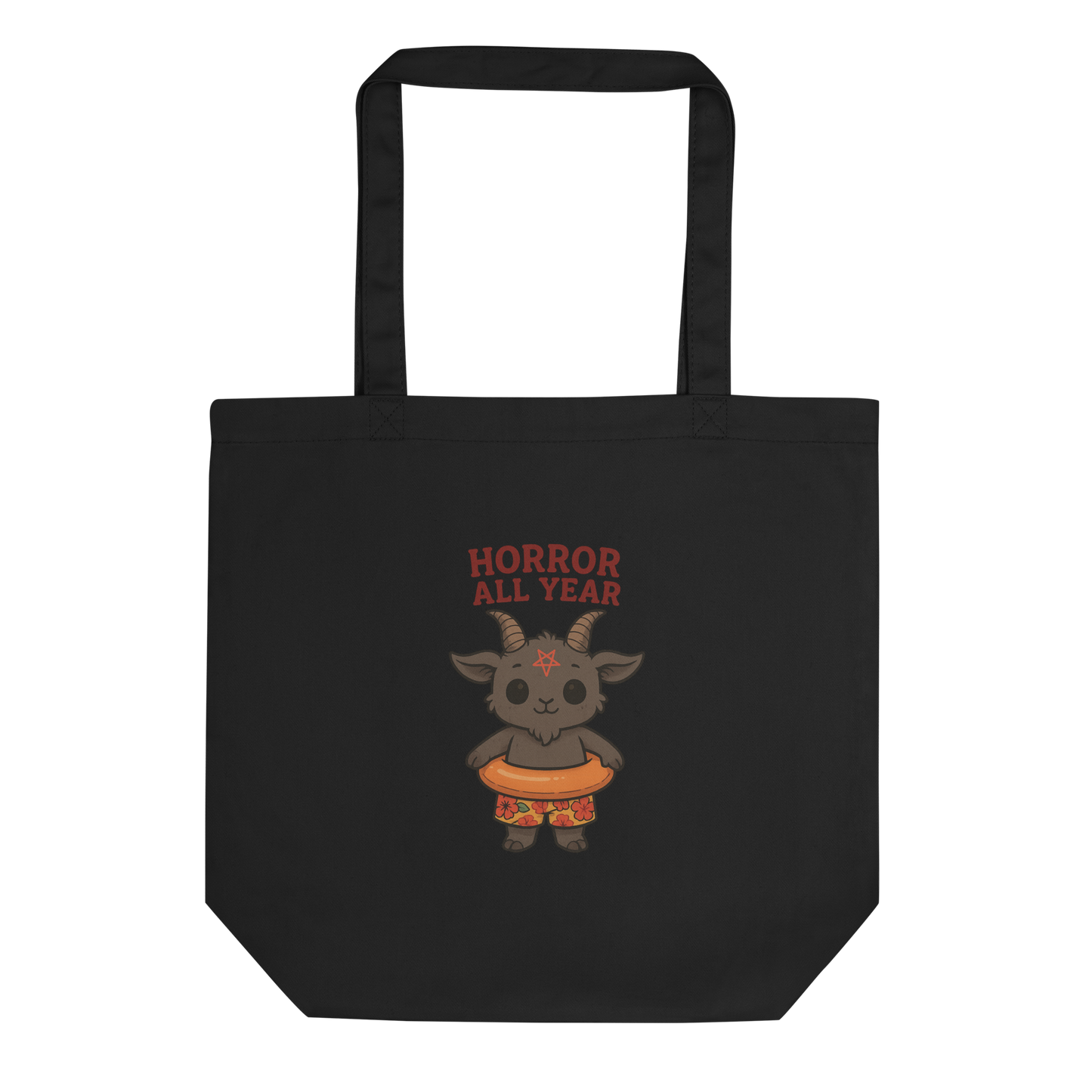This is a black tote bag that has a cartoon illustration of a baby Baphomet goat with curved horns and a playful grin, wearing bright floral swim trunks while floating in a colorful inner tube. The character is set against a light background with the bold text “Horror All Year” above in red letters 