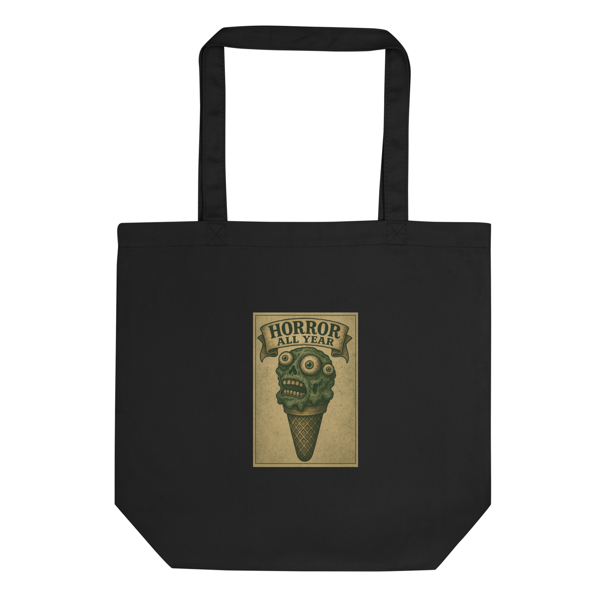 This is a black tote bag that is a vintage-style illustration of a zombie-themed ice cream cone with a green, melting undead face and bulging eyeballs. Above the cone, a horror banner reads "Horror All Year" on a distressed parchment background