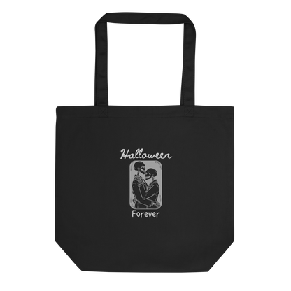This is a black tote bag that has a hugging skeleton couple that is grey and says Halloween Forever 