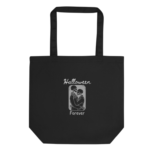 This is a black tote bag that has a hugging skeleton couple that is grey and says Halloween Forever 