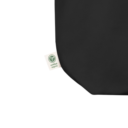 This is the tag of a black tote bag that has a hugging skeleton couple that is grey and says Halloween Forever on the front