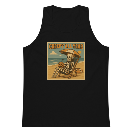 This is a black tank top with a retro-style illustration of a grinning skeleton lounging on a beach chair under an orange umbrella. The skeleton is holding a pumpkin-shaped drink cup with a straw and relaxing by the ocean, with a bright sun in the sky and a life preserver in the sand. The words “Creepy All Year” appear boldly at the top 