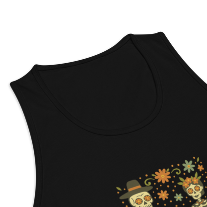 This is a zoom in of a black men's tank top with a Día de los Muertos–style illustration of a male and female skeleton holding hands, surrounded by marigolds, vines, and folk art patterns. The skeletons wear traditional black clothing, the man in a suit and hat, the woman with a floral crown with a red heart and leaves at the bottom and the text Creepy All Year. Rendered in warm tones of orange, green, and cream, symbolizing eternal love and remembrance