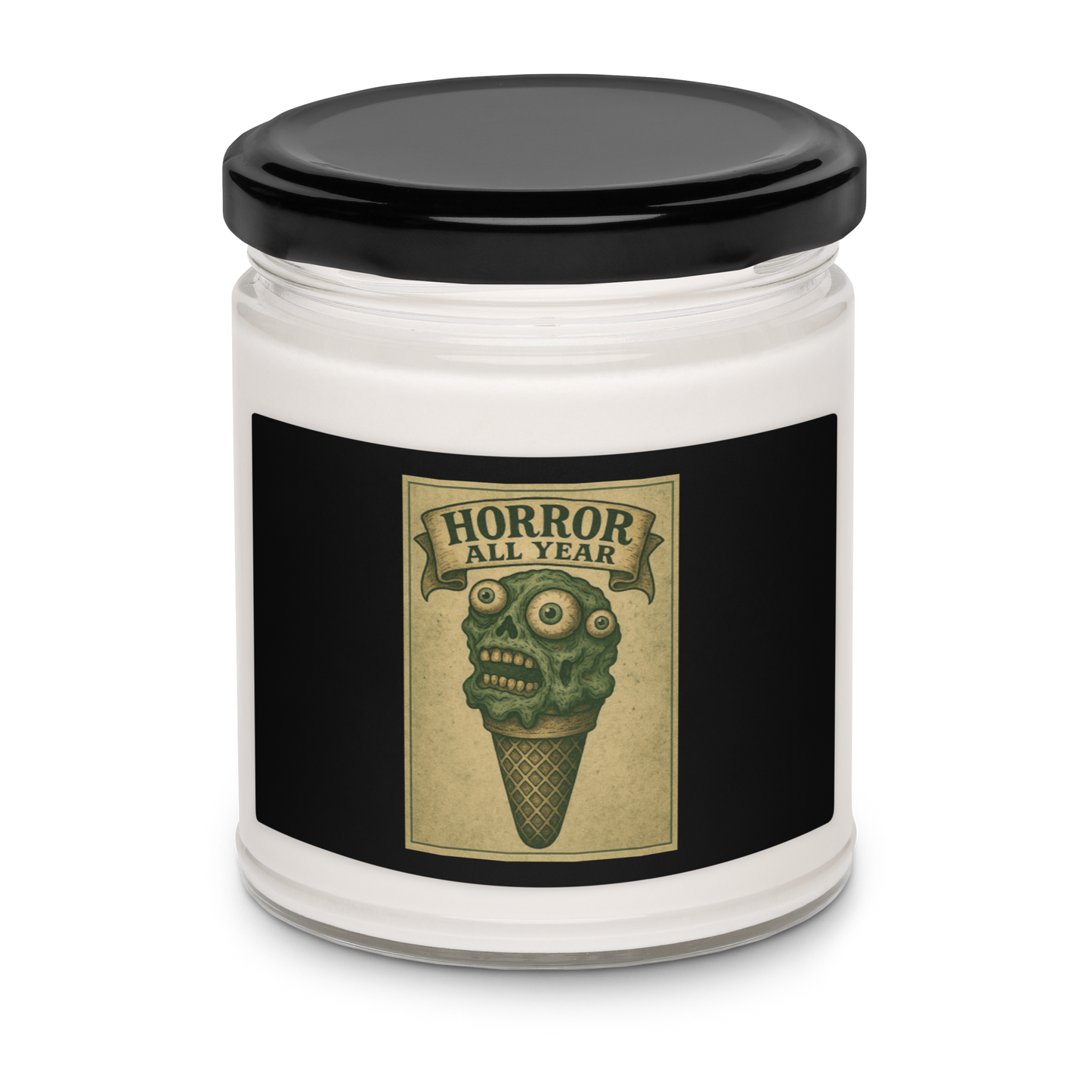 This is a candle with black tin lid and  black label that is a vintage-style illustration of a zombie-themed ice cream cone with a green, melting undead face and bulging eyeballs. Above the cone, a horror banner reads "Horror All Year" on a distressed parchment background