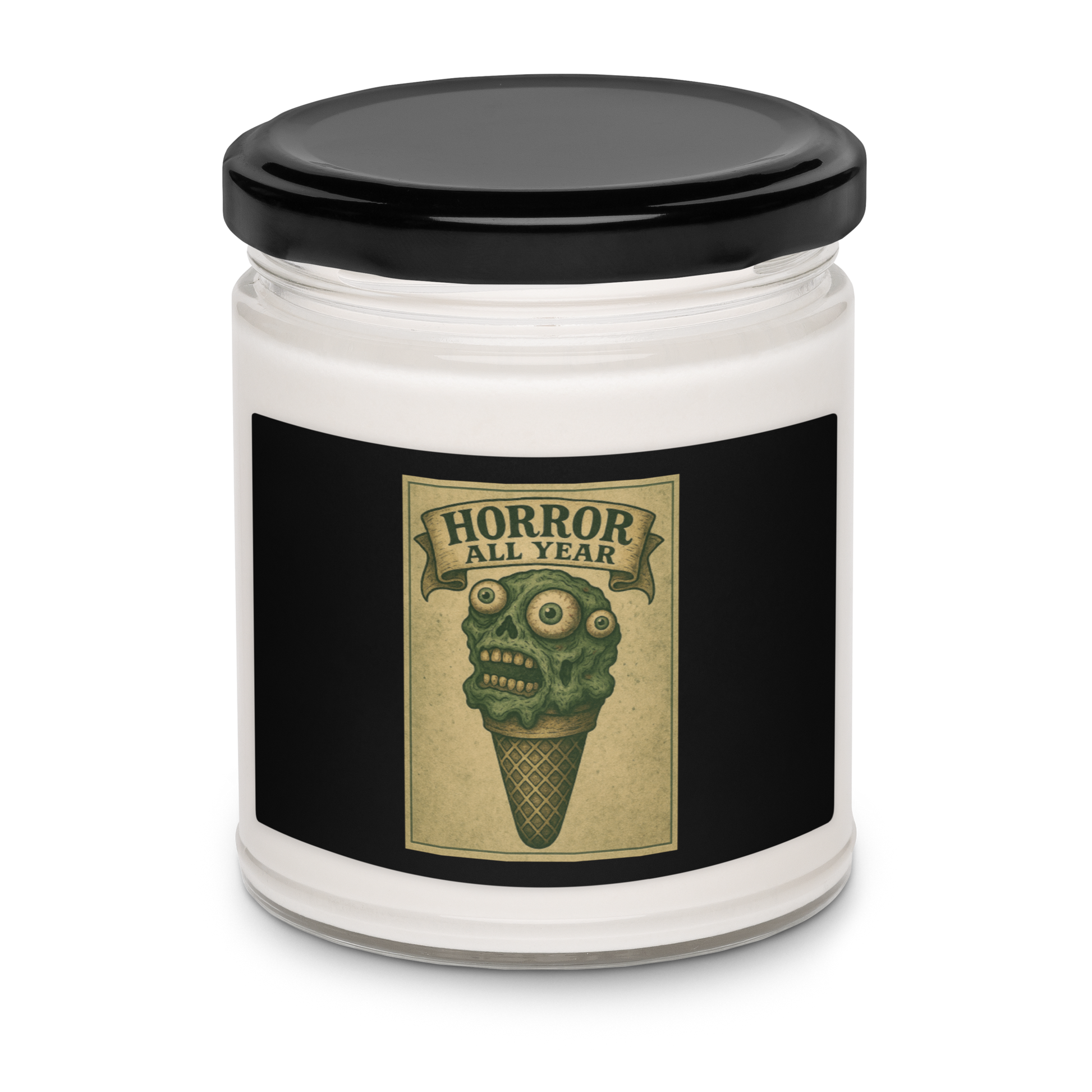 This is a candle with black tin lid and  black label that is a vintage-style illustration of a zombie-themed ice cream cone with a green, melting undead face and bulging eyeballs. Above the cone, a horror banner reads "Horror All Year" on a distressed parchment background