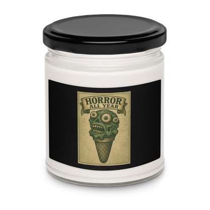 This is a candle with black tin lid and  black label that is a vintage-style illustration of a zombie-themed ice cream cone with a green, melting undead face and bulging eyeballs. Above the cone, a horror banner reads "Horror All Year" on a distressed parchment background