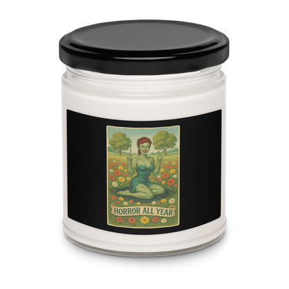 This is a candle with a black label with a design illustration of a sassy zombie pinup girl standing in a floral field, wearing tattered lingerie and flipping off the viewer with both hands. She has green skin, vintage curls, and a bold attitude. The design blends horror and humor, with a pastel color palette and creepy cute vibes
