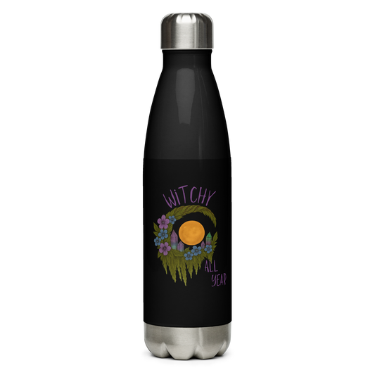 This is a black stainless steel water bottle  with a design of a hand-drawn wreath made of moss-covered branches wraps around a glowing sun. The wreath is decorated with purple and blue flowers, small amethyst and fluorite crystals, and strands of hanging moss. The words “Witchy” curve above the wreath and “All Year” sits on the bottom right 