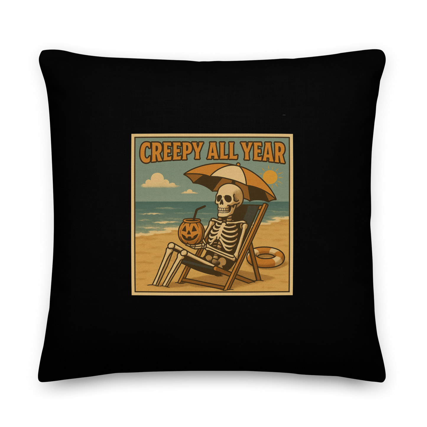 This is a black throw pillow with a retro-style illustration of a grinning skeleton lounging on a beach chair under an orange umbrella. The skeleton is holding a pumpkin-shaped drink cup with a straw and relaxing by the ocean, with a bright sun in the sky and a life preserver in the sand. The words “Creepy All Year” appear boldly at the top 