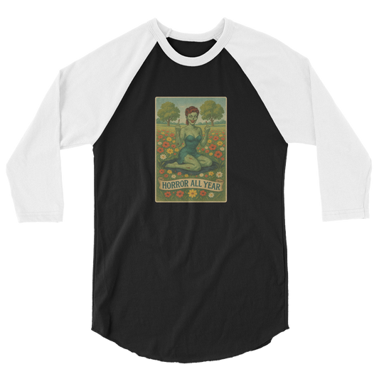 This is a black and white raglan shirt with a design illustration of a sassy zombie pinup girl standing in a floral field, wearing tattered lingerie and flipping off the viewer with both hands. She has green skin, vintage curls, and a bold attitude. The design blends horror and humor, with a pastel color palette and creepy cute vibes