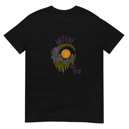 This is a black t-shirt with a design of a hand-drawn wreath made of moss-covered branches wraps around a glowing sun. The wreath is decorated with purple and blue flowers, small amethyst and fluorite crystals, and strands of hanging moss. The words “Witchy” curve above the wreath and “All Year” sits on the bottom right 