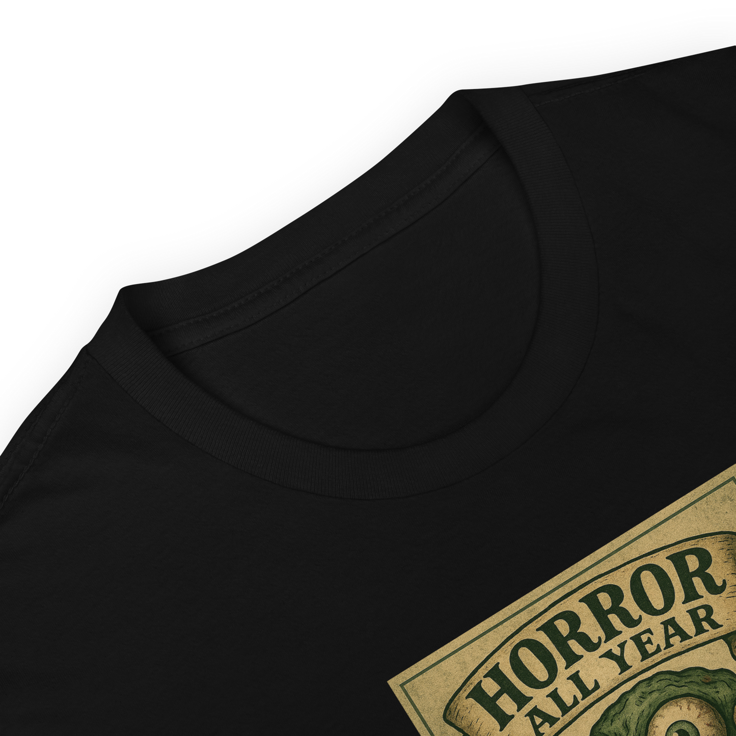 This is a zoom in of a black t-shirt that is a vintage-style illustration of a zombie-themed ice cream cone with a green, melting undead face and bulging eyeballs. Above the cone, a horror banner reads "Horror All Year" on a distressed parchment background