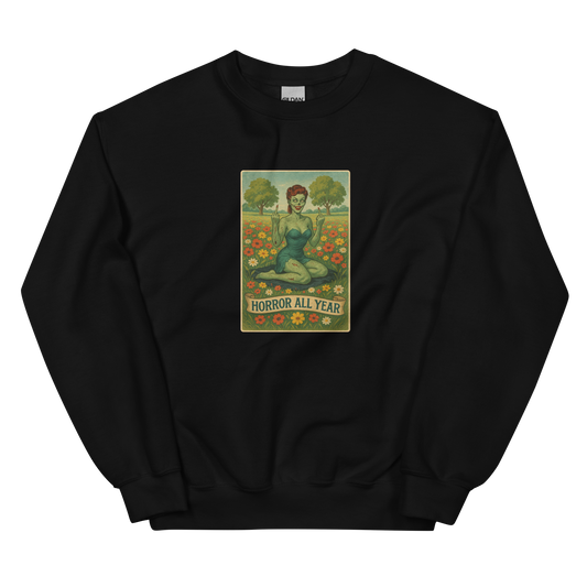 This is a black sweatshirt with a design illustration of a sassy zombie pinup girl standing in a floral field, wearing tattered lingerie and flipping off the viewer with both hands. She has green skin, vintage curls, and a bold attitude. The design blends horror and humor, with a pastel color palette and creepy cute vibes