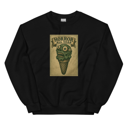 This is a black sweatshirt that is a vintage-style illustration of a zombie-themed ice cream cone with a green, melting undead face and bulging eyeballs. Above the cone, a horror banner reads "Horror All Year" on a distressed parchment background