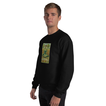 This is a man with blonde hair wearing a black sweatshirt with a design illustration of a sassy zombie pinup girl standing in a floral field, wearing tattered lingerie and flipping off the viewer with both hands. She has green skin, vintage curls, and a bold attitude. The design blends horror and humor, with a pastel color palette and creepy cute vibes