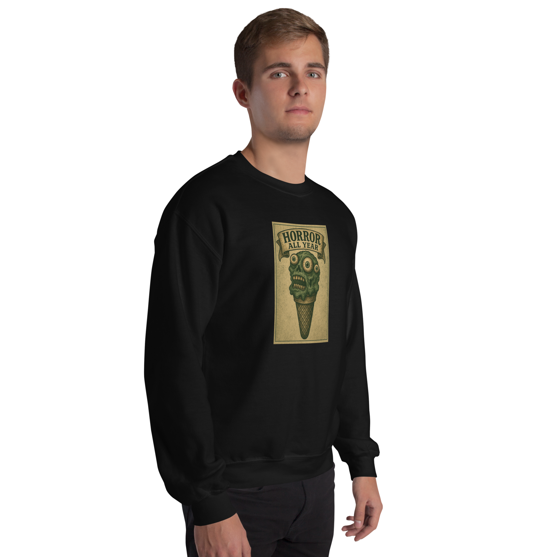 This is a man with brown hair wearing a black sweatshirt that is a vintage-style illustration of a zombie-themed ice cream cone with a green, melting undead face and bulging eyeballs. Above the cone, a horror banner reads "Horror All Year" on a distressed parchment background