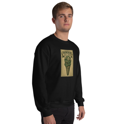 This is a man with brown hair wearing a black sweatshirt that is a vintage-style illustration of a zombie-themed ice cream cone with a green, melting undead face and bulging eyeballs. Above the cone, a horror banner reads "Horror All Year" on a distressed parchment background
