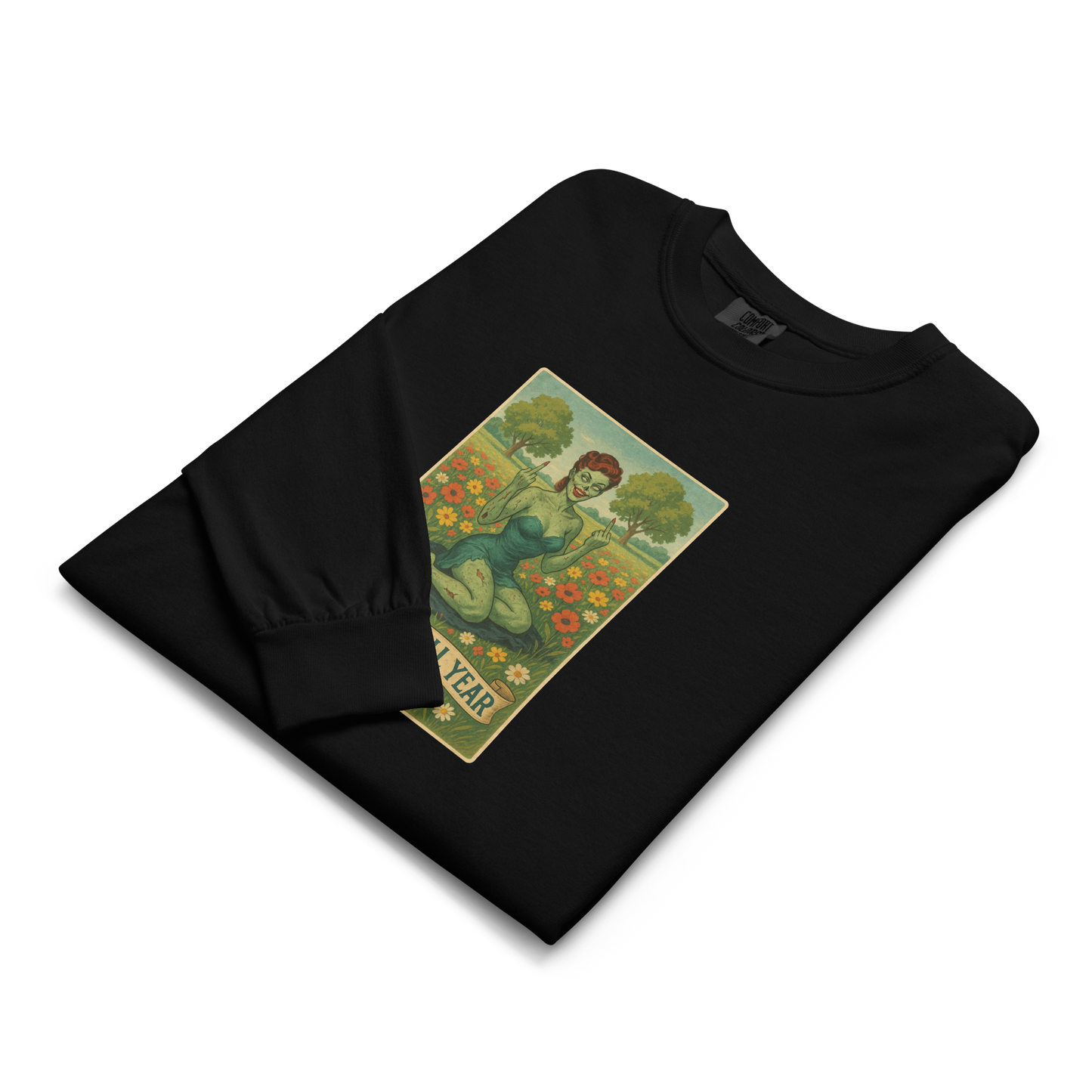 This is a folded black long sleeve shirt with a design illustration of a sassy zombie pinup girl standing in a floral field, wearing tattered lingerie and flipping off the viewer with both hands. She has green skin, vintage curls, and a bold attitude. The design blends horror and humor, with a pastel color palette and creepy cute vibes