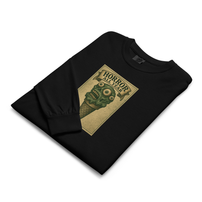 This is a folded black long sleeve shirt that is a vintage-style illustration of a zombie-themed ice cream cone with a green, melting undead face and bulging eyeballs. Above the cone, a horror banner reads "Horror All Year" on a distressed parchment background