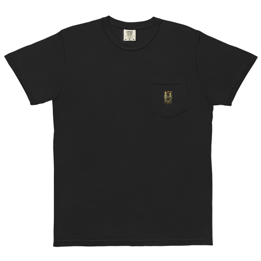 This is a black pocket t-shirt with a Día de los Muertos–style illustration of a male and female skeleton holding hands, surrounded by marigolds, vines, and folk art patterns. The skeletons wear traditional black clothing, the man in a suit and hat, the woman with a floral crown with a red heart and leaves at the bottom and the text Creepy All Year. Rendered in warm tones of orange, green, and cream, symbolizing eternal love and remembrance