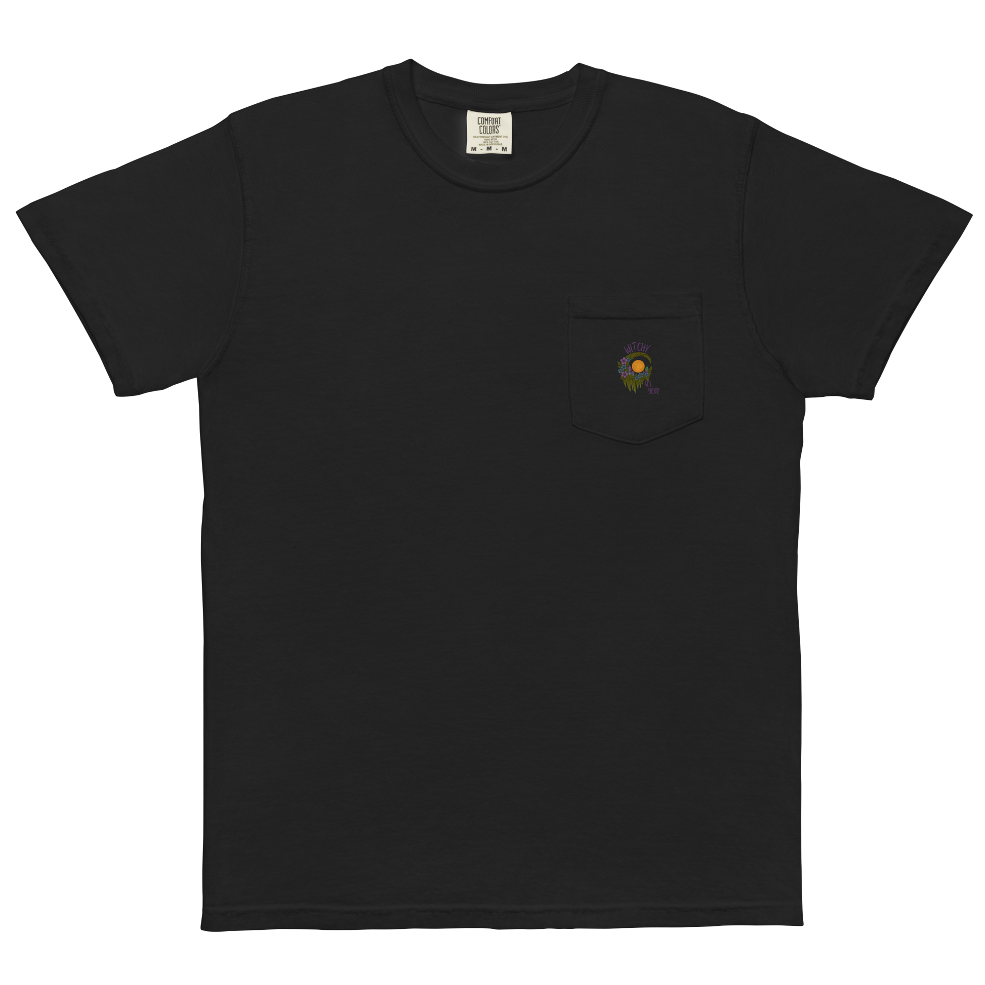 This is a black pocket t-shirt with a design of a hand-drawn wreath made of moss-covered branches wraps around a glowing sun. The wreath is decorated with purple and blue flowers, small amethyst and fluorite crystals, and strands of hanging moss. The words “Witchy” curve above the wreath and “All Year” sits on the bottom right 